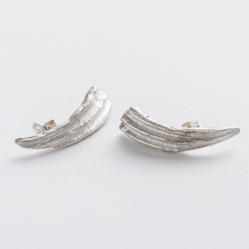 Silver seashell ear climber. Handcarved in wac, cast in recycled silver. Can also be worn as a statement stud earring.