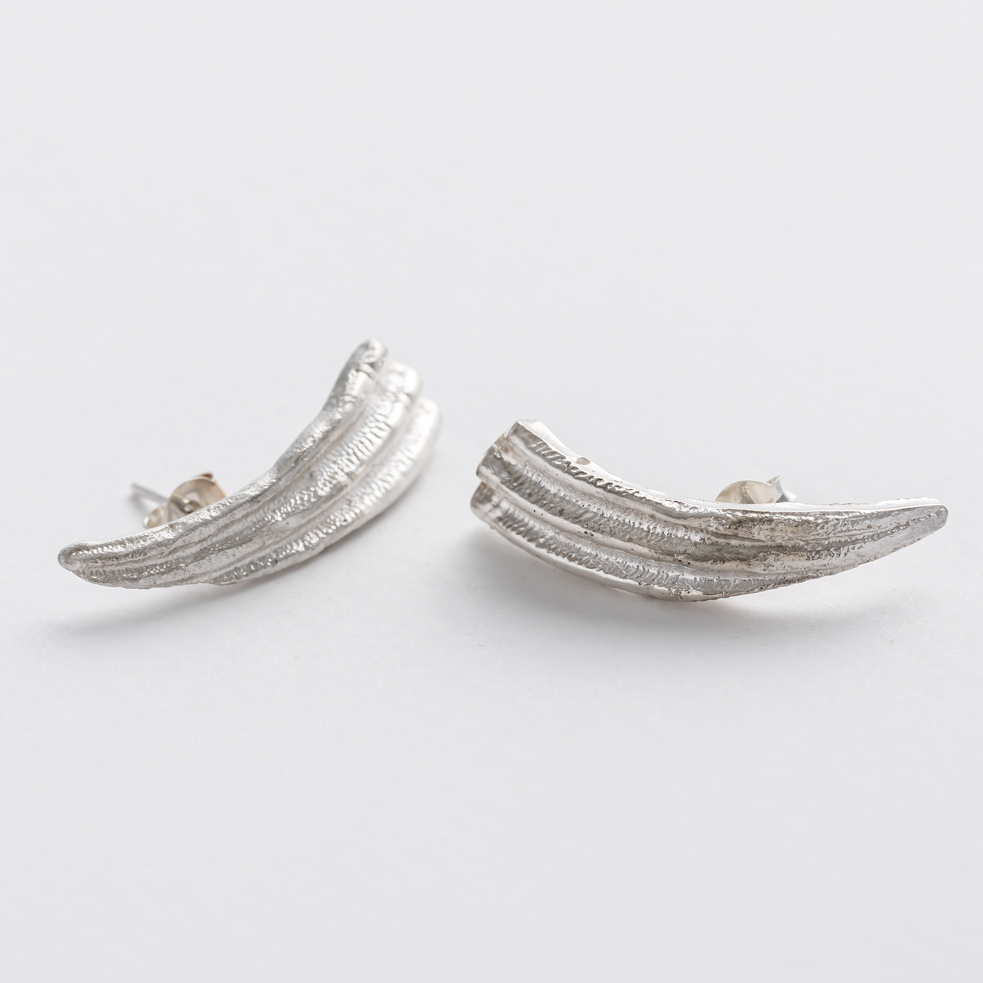 Silver seashell ear climber. Handcarved in wax, cast in recycled silver. Can also be worn as a statement stud earring.