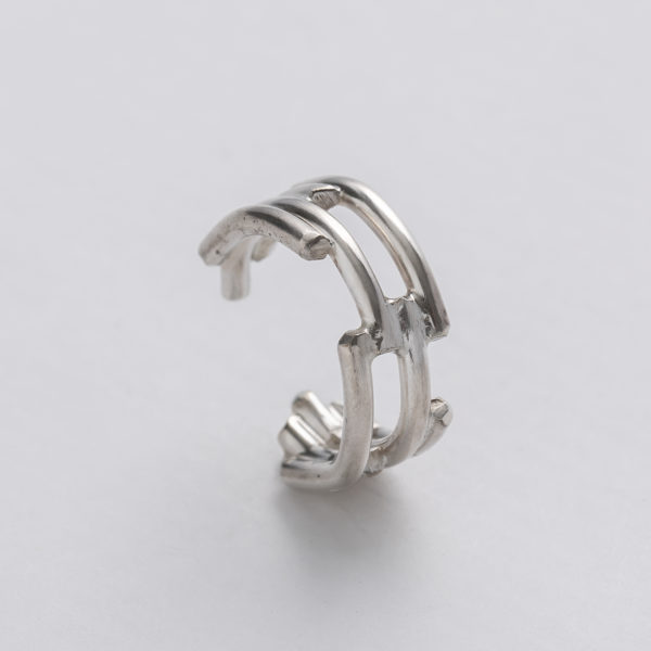 Handmade recycled silver wire ear cuff with linear pattern